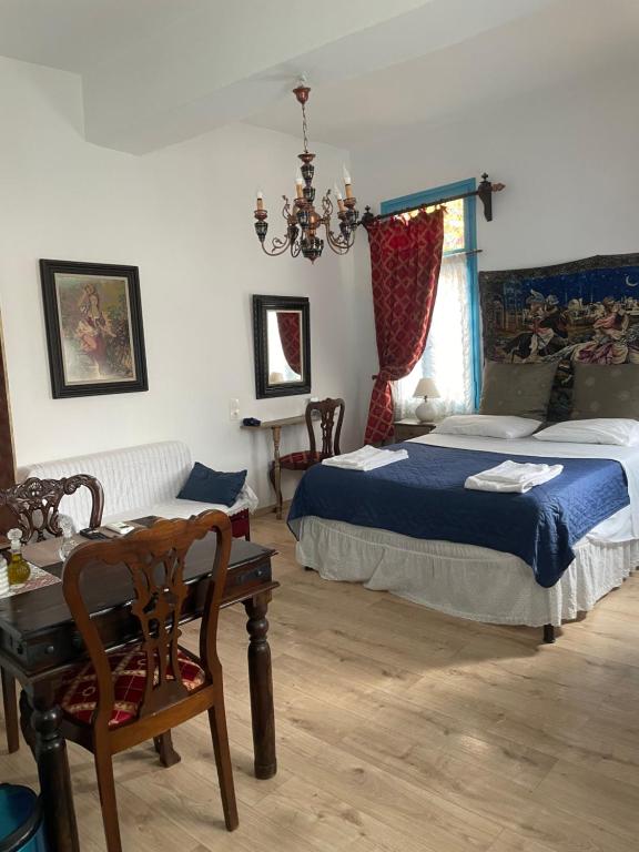 a bedroom with a bed and a table and a chair at DIONI 2 in Chania Town