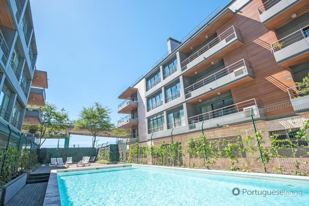 a swimming pool in front of a building at Beautiful design Belem Ap 115m2 in Lisbon