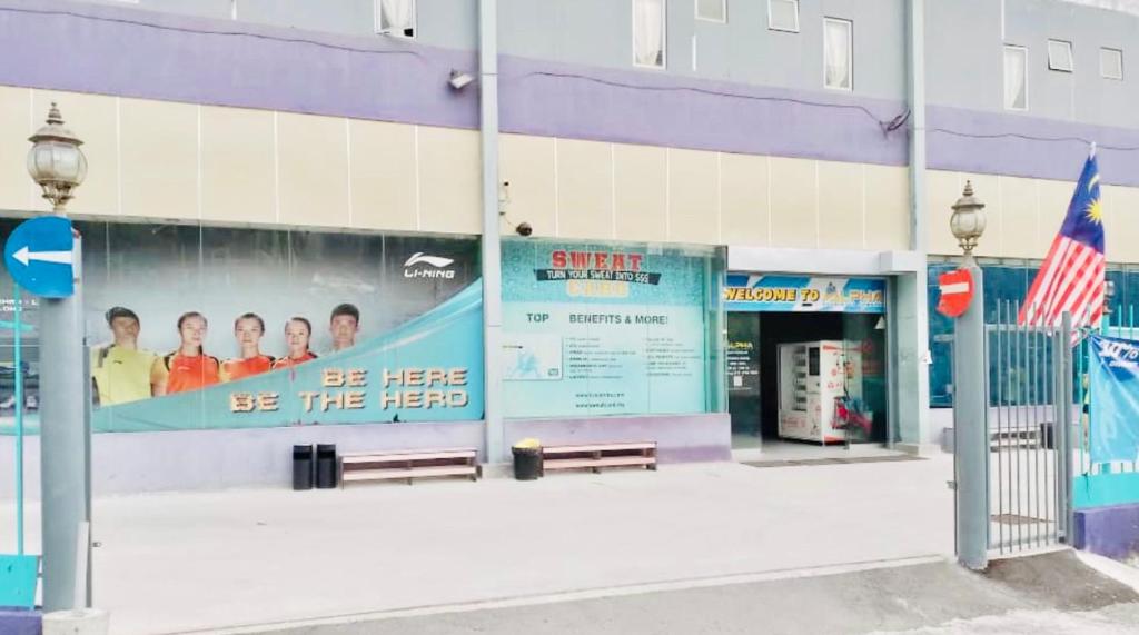 a building with a large sign on the side of it at ABC Hostel in Seri Kembangan