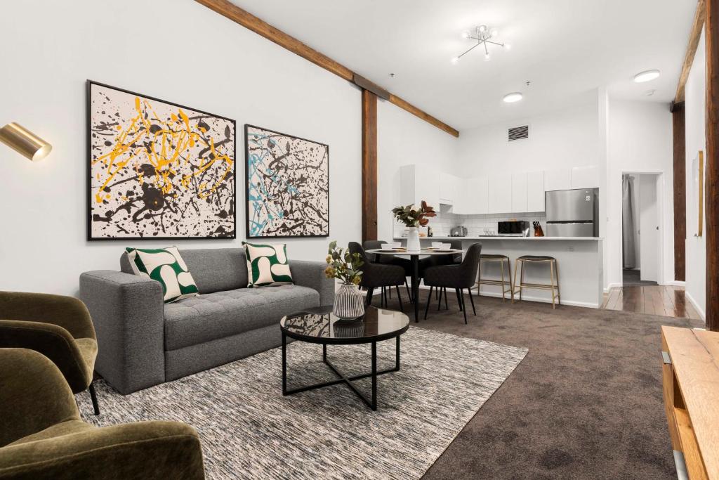 a living room with a couch and a table at 1 BR Apartment In the Heart of Darling Harbour in Sydney