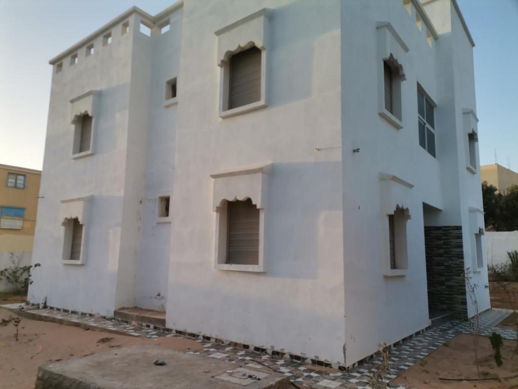 a white building with windows on the side at Villa in Tamri Agadir in Agadir