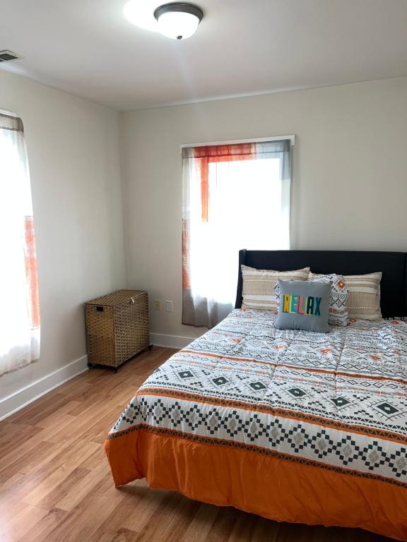 a bedroom with a bed and two windows at The Zen Home near Temple U & Drexel FREE STREET PARKING in Philadelphia