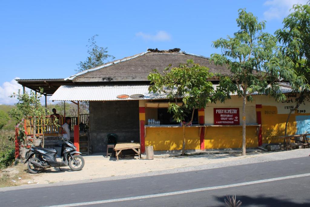 a motorcycle parked in front of a building at Feby's Homestay in Ekas