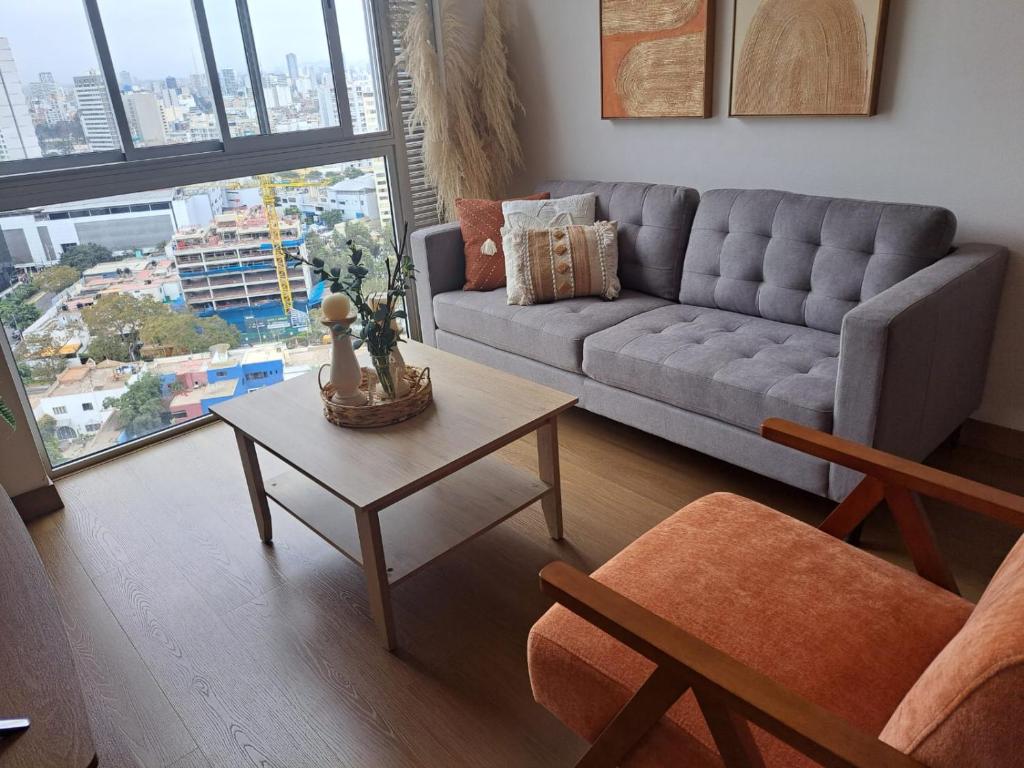 a living room with a couch and a table at Departamento Exclusivo clase A in Lima