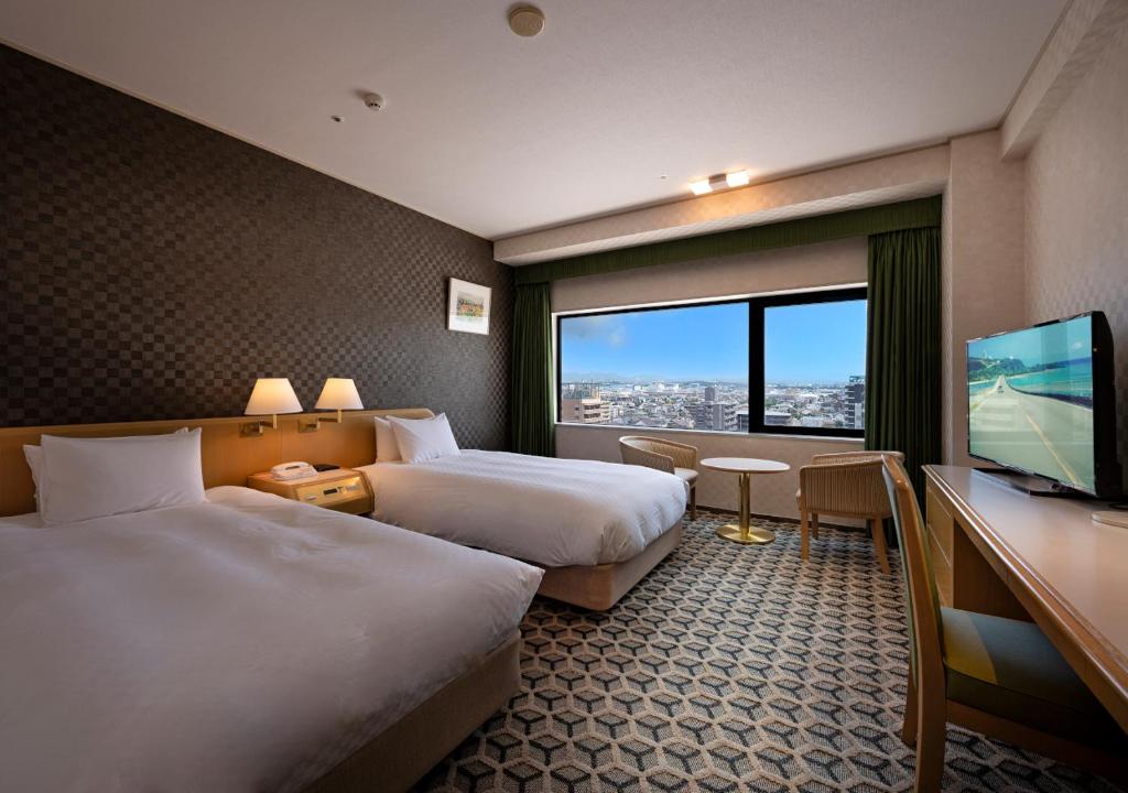 Postel nebo postele na pokoji v ubytování Meitetsu Komaki Hotel