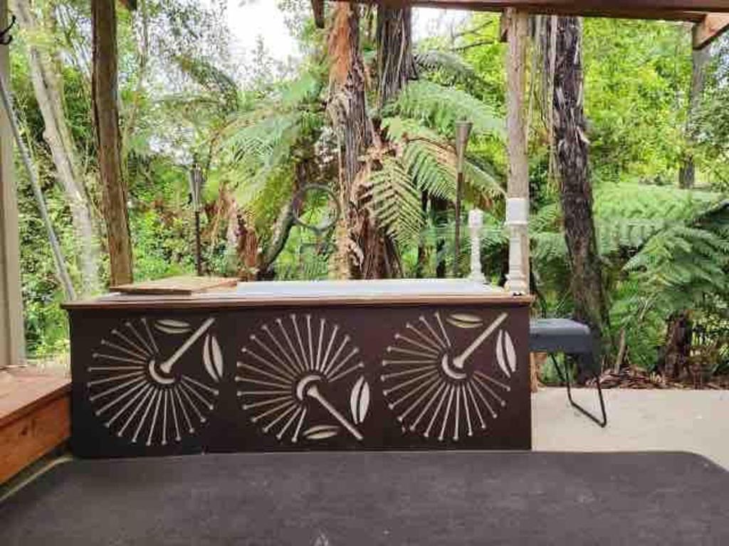 a wooden table with a black and white pattern on it at Charming Country Retreat in Hamilton