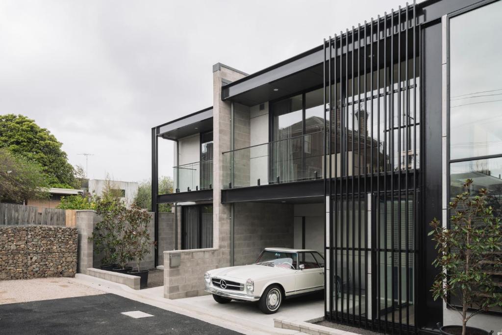 a white car parked in front of a house at Stadium View Townhouse in Geelong