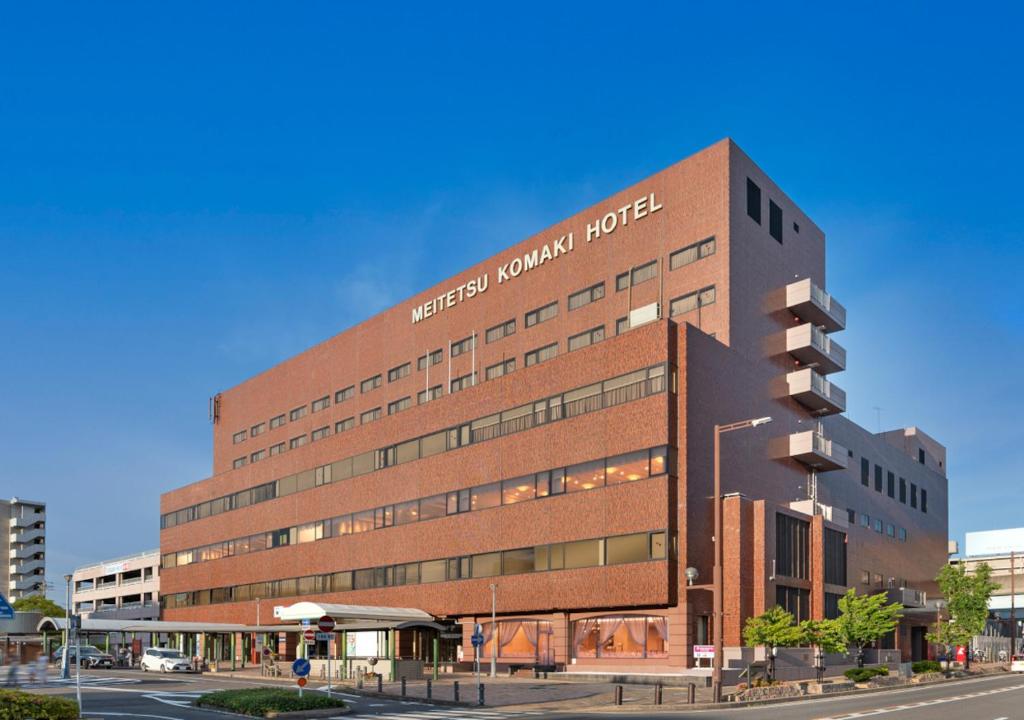 a building with a sign on the side of it at Meitetsu Komaki Hotel in Komaki