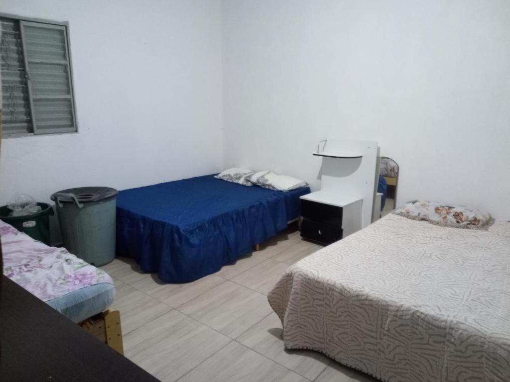 a room with two beds and a printer in it at Casa chacara próx Tomorrowland itu in Itu