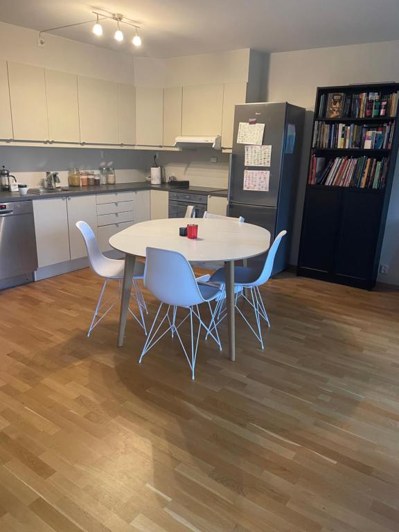 a kitchen with a table and chairs and a refrigerator at Maria’s place central in Oslo in Oslo
