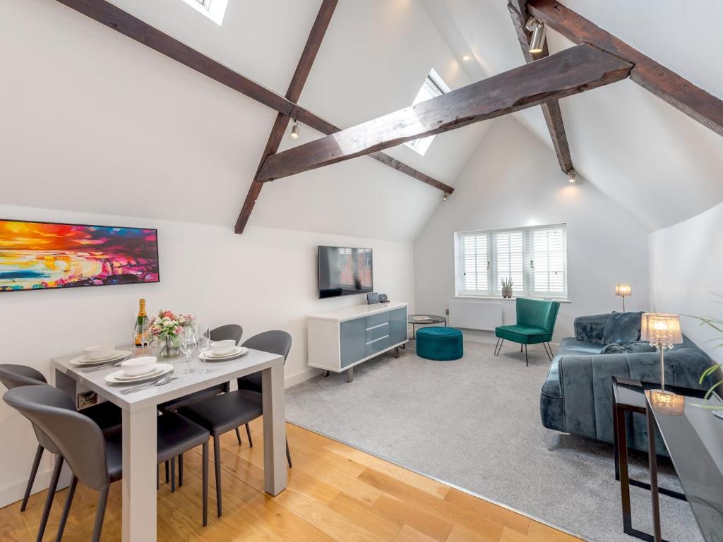 a living room with a table and chairs and a couch at Pass the Keys 40C 2 bed Celosia Beautiful Town Centre Apartment in Shrewsbury