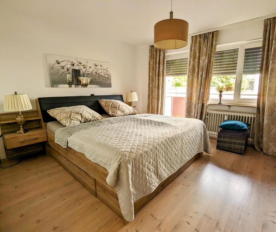 sypialnia z dużym łóżkiem i drewnianą podłogą w obiekcie Rastatt Retreat: Zentral und Gemütlich w mieście Rastatt