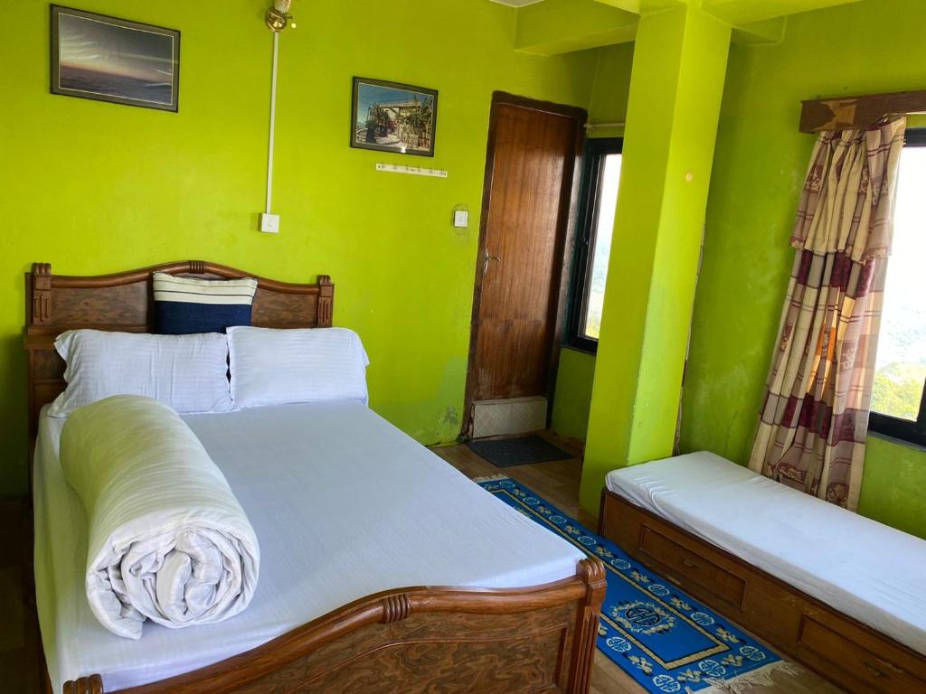 Letto o letti in una camera di Panoramic View Guest House Sarangkot
