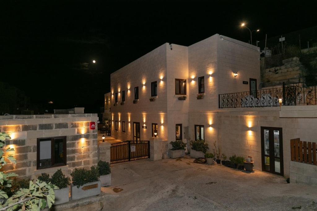 a large white building with lights on it at night at Ta' Gingel Farm Agriturisim B&B. Malta in St. Paul's Bay