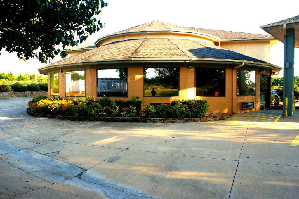 a building with a porch with a sidewalk in front at Van Buren Inn in Van Buren