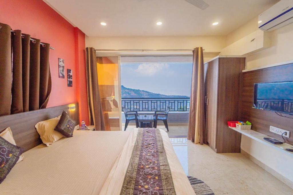 a bedroom with a bed with a view of the ocean at Polsburg Panchgani in Panchgani