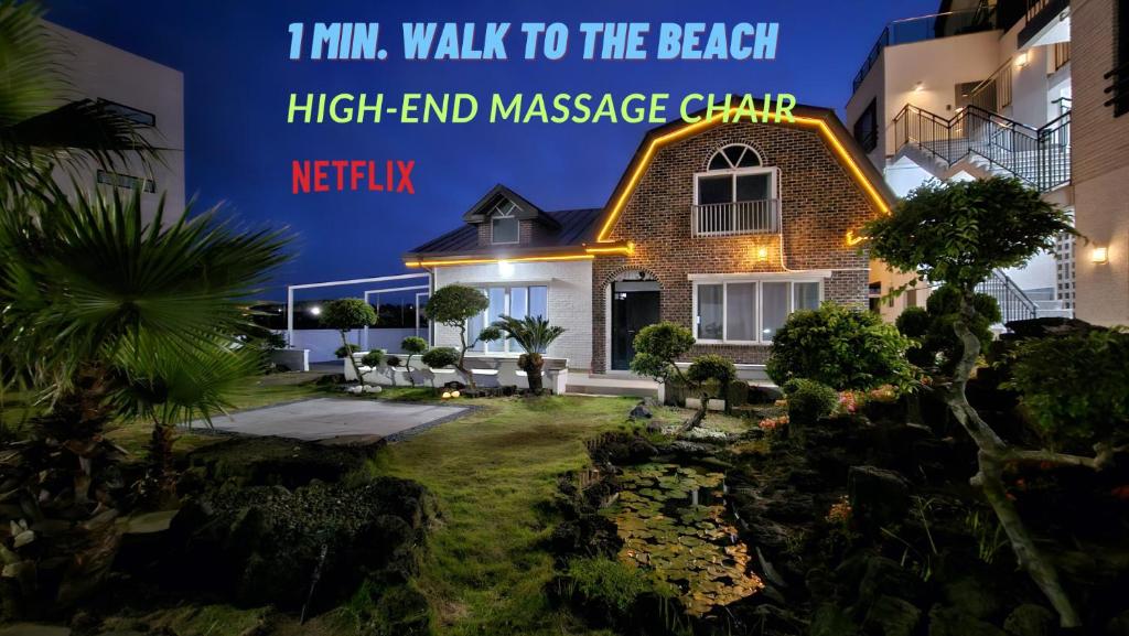 a house with the words ihm walk to the beach high end massage chain at Someday Jeju in Jeju