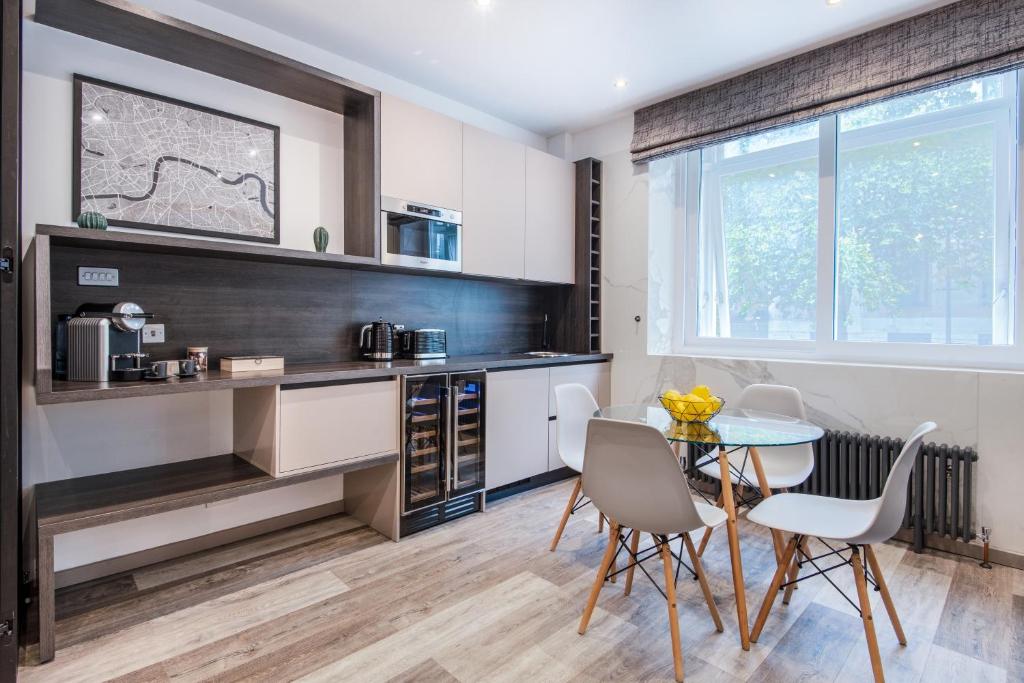 a kitchen with a table and chairs in a room at Circlelet Luxury Private Suite 2 in London