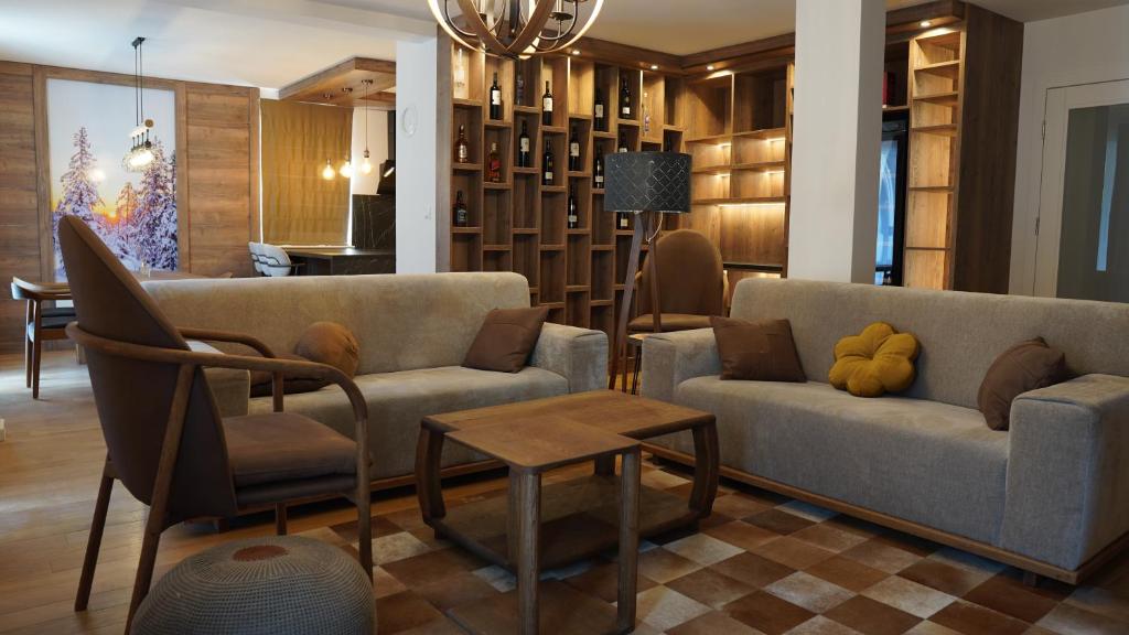 a living room with two couches and a table at Snjezna Dolina Resort - Jahorina in Jahorina