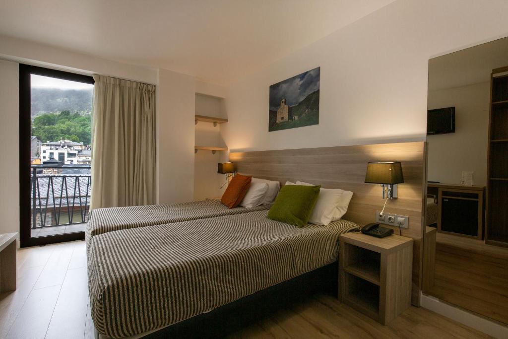 Postel nebo postele na pokoji v ubytování Hotel Del Pui