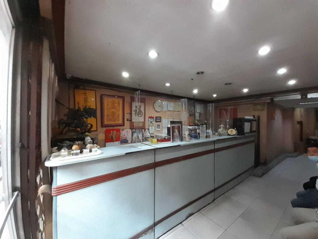 a kitchen with a long counter in a room at OYO 1011 First Hotel in Manila