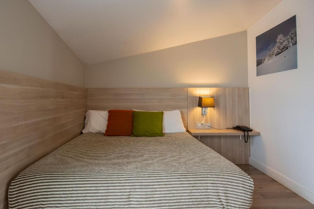 Postel nebo postele na pokoji v ubytování Hotel Del Pui