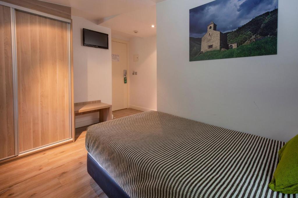 Postel nebo postele na pokoji v ubytování Hotel Del Pui