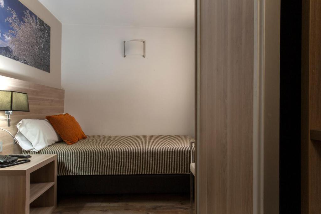 Postel nebo postele na pokoji v ubytování Hotel Del Pui