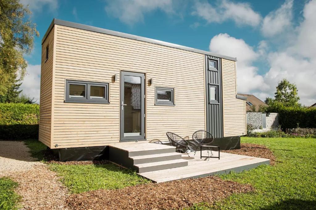 a tiny house with a staircase and a chair at Tiny Om Ferienhaus in Laichingen