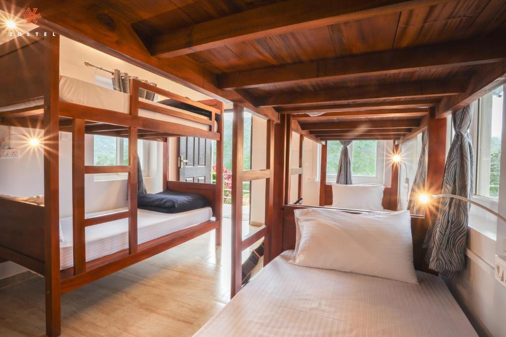 a bedroom with two bunk beds in a room at Zostel Vagamon in Vagamon
