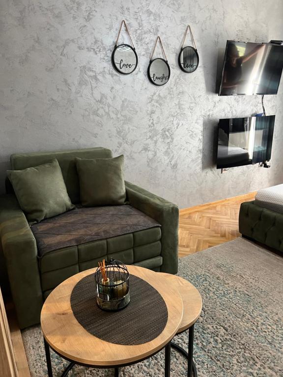 een woonkamer met een bank en een tafel bij Apartman Didi2- free private parking-garage in Novi Sad