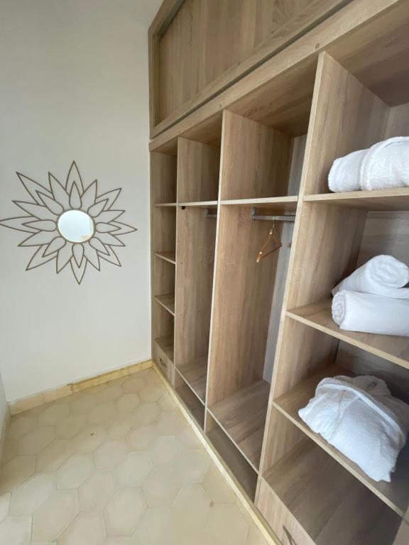 a closet with wooden shelves and towels in it at Villa La Falaise in Oualidia