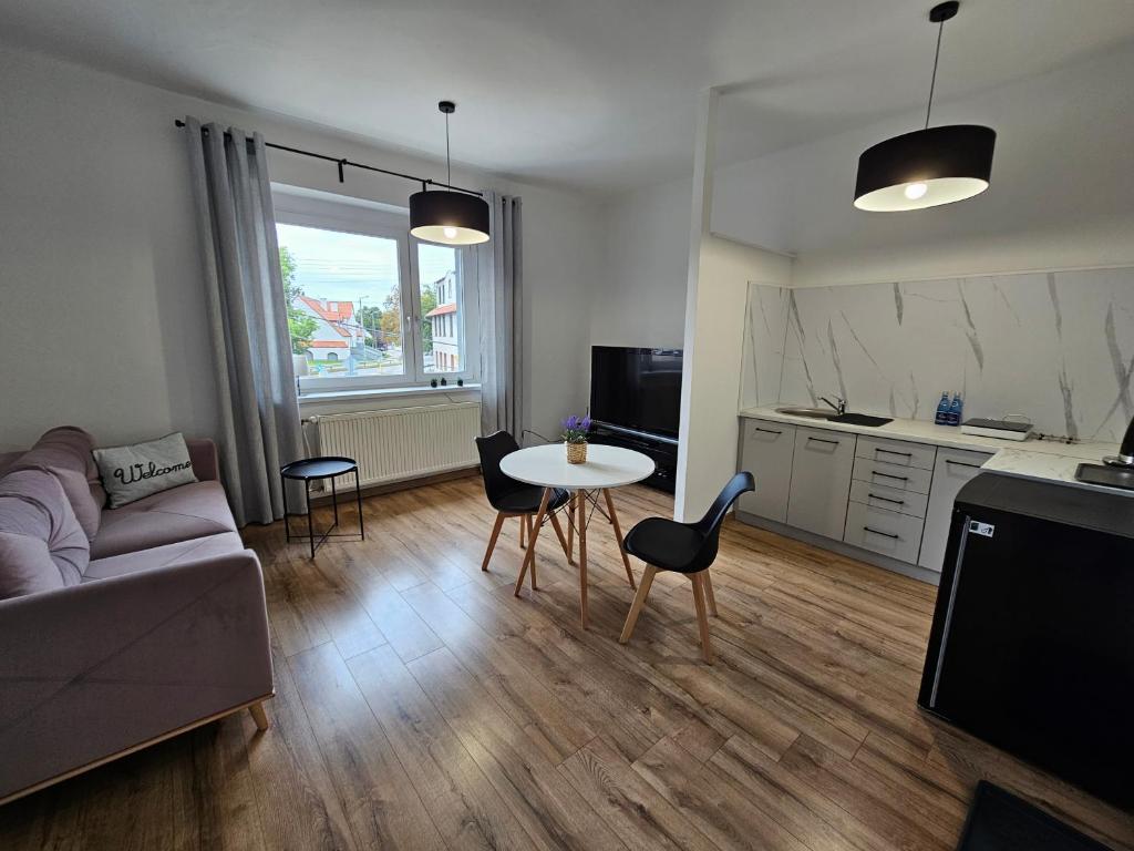 a living room with a couch and a table at Apartamenty HARDOM in Opole