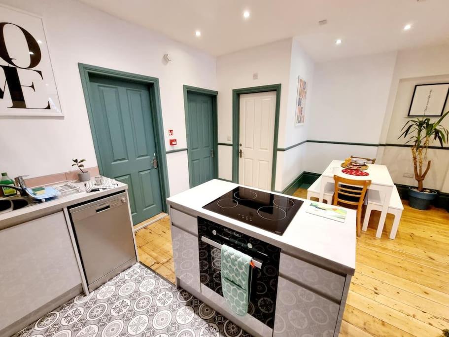 a kitchen with a stove top oven in a room at Central Location with Garden in Seaford