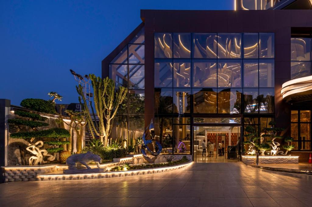 a building at night with a pathway in front of it at Mirage Hotel & Conference Center in Alexandria