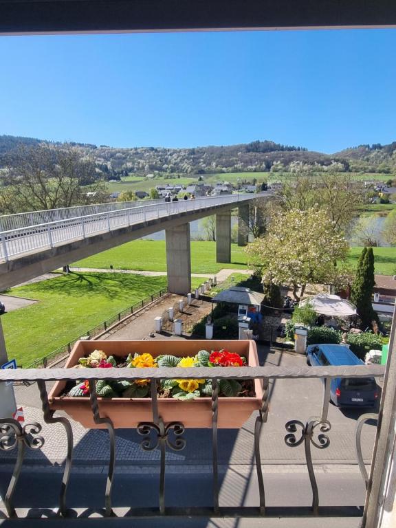 a balcony with a flower planter on a bridge at Moselblick in Kinheim