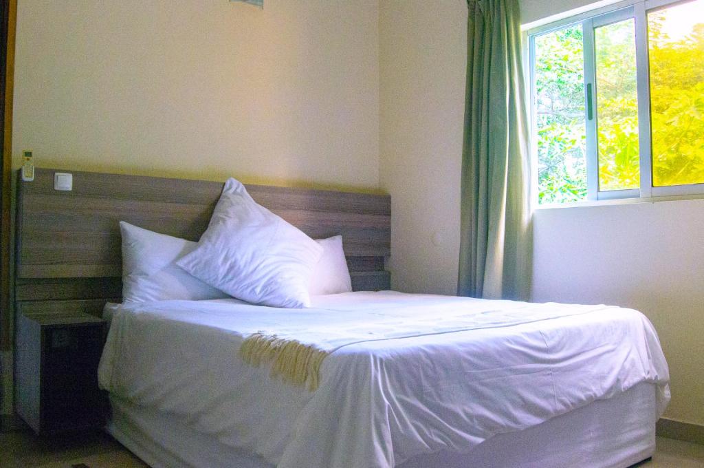 Postel nebo postele na pokoji v ubytování Ponta View Hotel