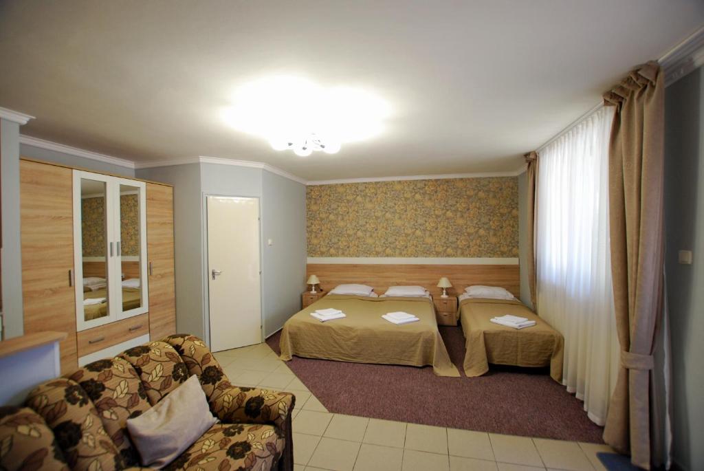 Postel nebo postele na pokoji v ubytování Aurora Ház