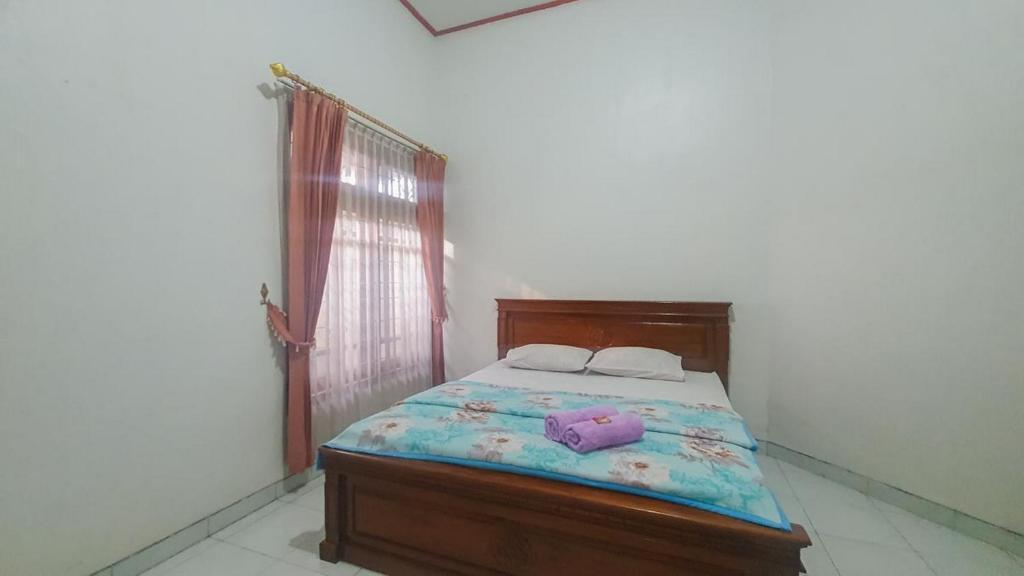 a bedroom with a bed with two towels on it at Villa Pakis Residence Banyuwangi in Banyuwangi