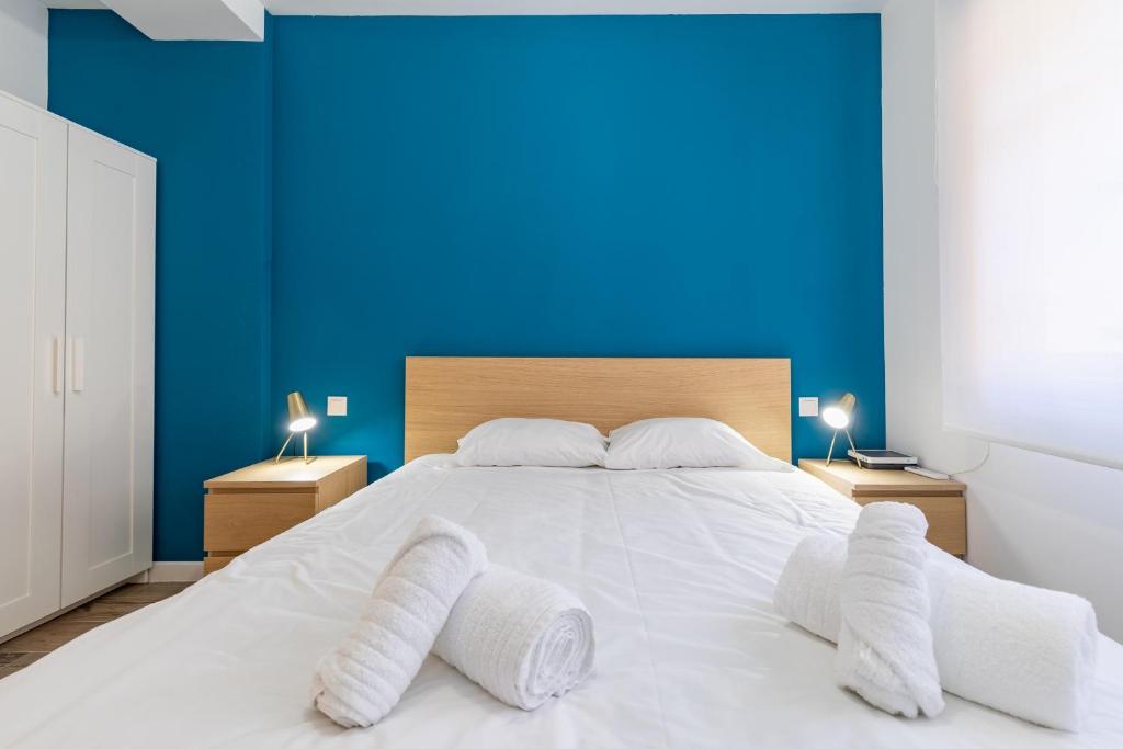 Posteľ alebo postele v izbe v ubytovaní ApartUP Ruzafa Vertical
