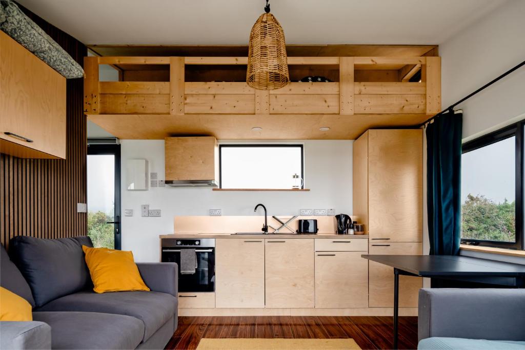 a living room with a couch and a kitchen at Goleen Harbour in Goleen