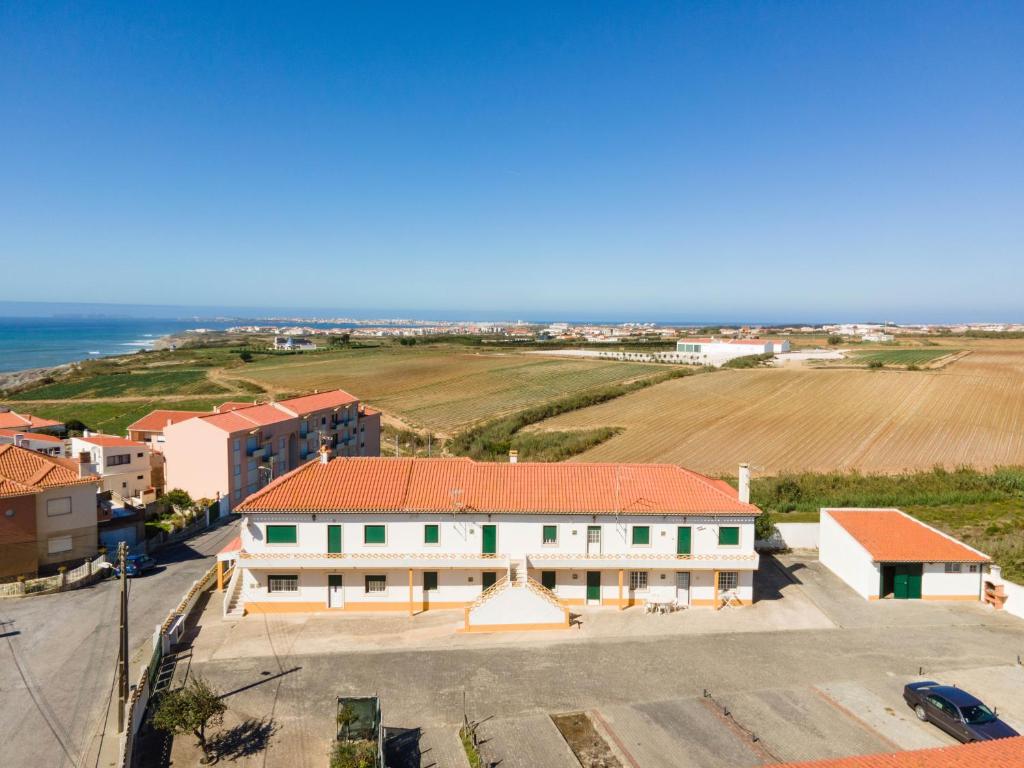 - une vue aérienne sur un bâtiment et l'océan dans l'établissement Tilli'n'Joe's Beach House, à Atouguia da Baleia