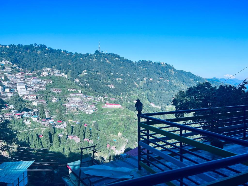 a view of a mountain with a town on a hill at Irish Town Mussoorie in Mussoorie
