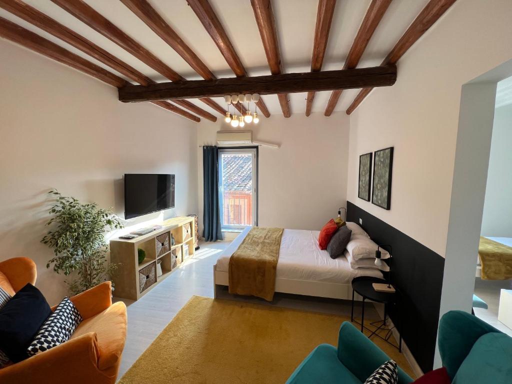 a bedroom with a bed and a tv and a couch at Charming Navona in Rome