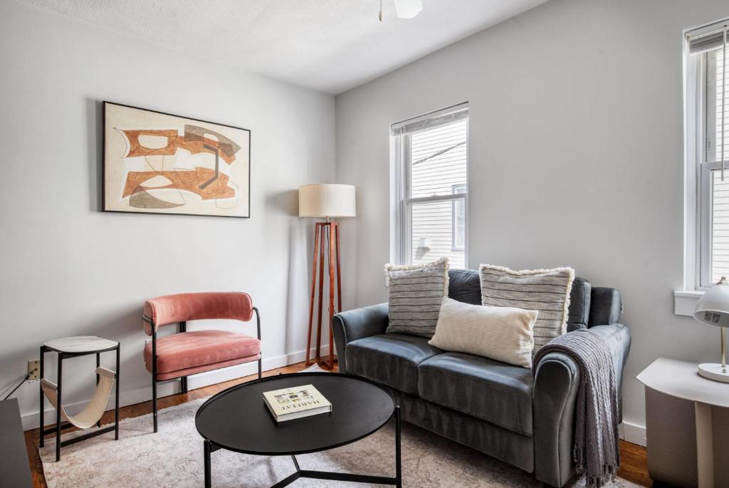 a living room with a couch and a chair at South Boston 2br w building wd nr seaport BOS-912 in Boston