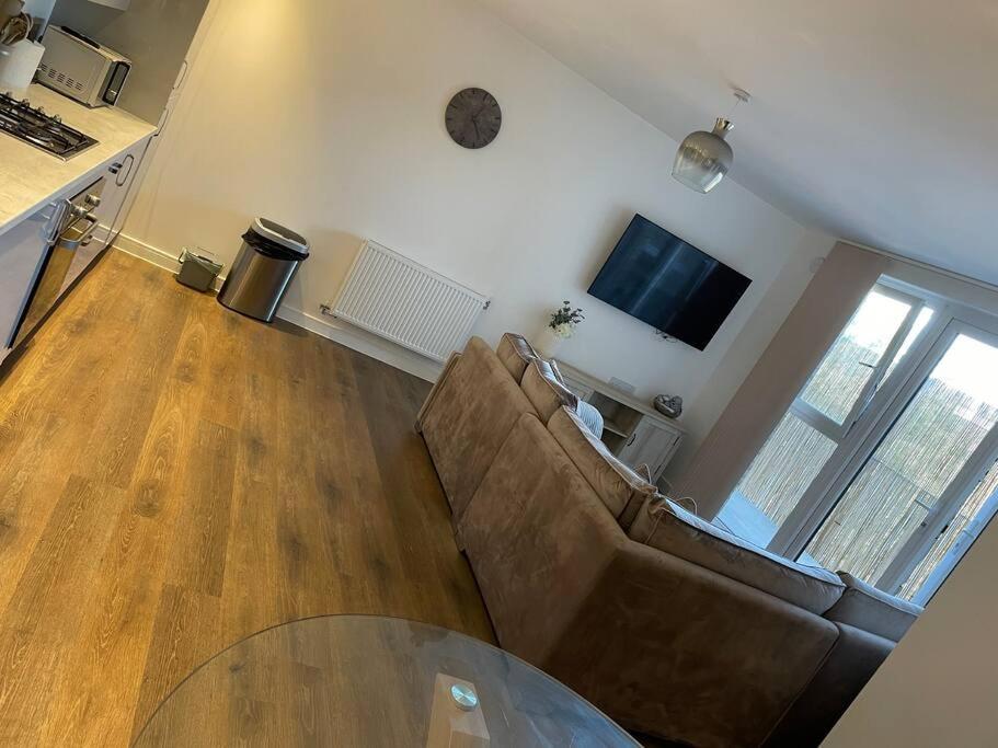 a living room with a couch and a table at Flat in the Heart of Chelmsford in Chelmsford