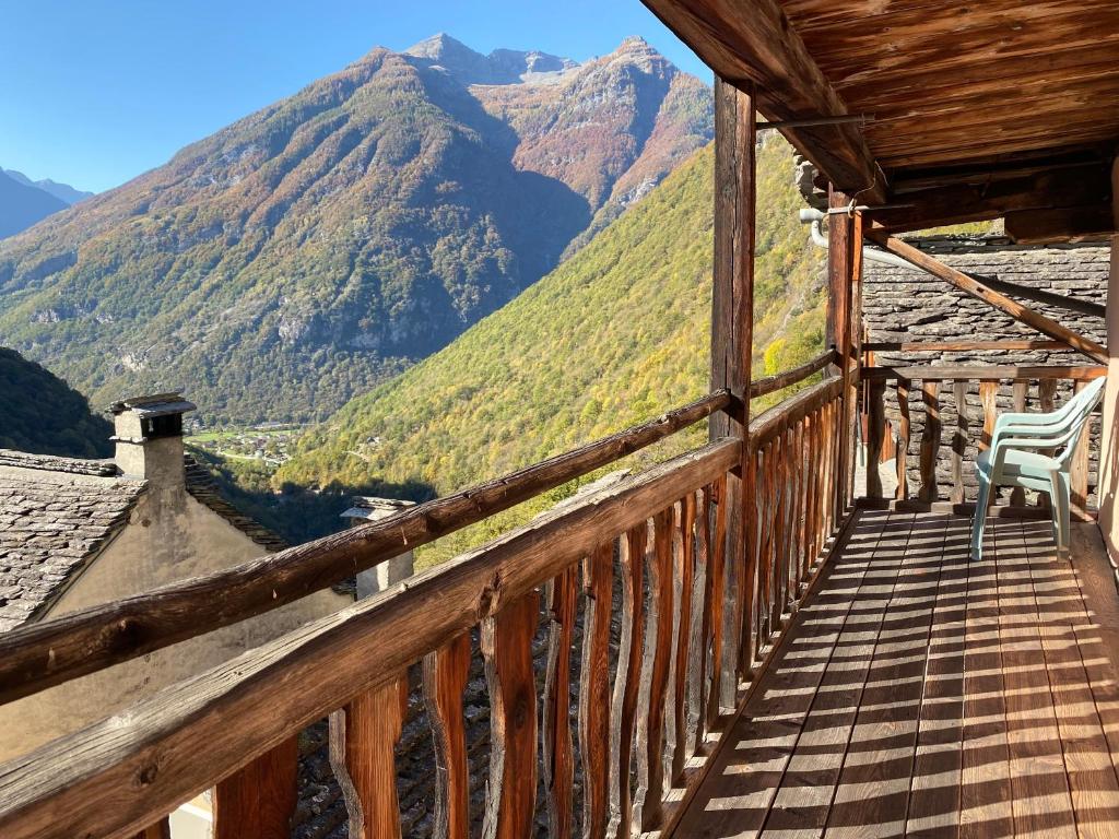 a wooden balcony with a view of mountains at Casa nonna Domenica in Brontallo
