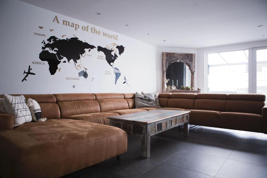 a living room with a couch and a map of the world at Luxurious House in Kerkrade Center in Kerkrade