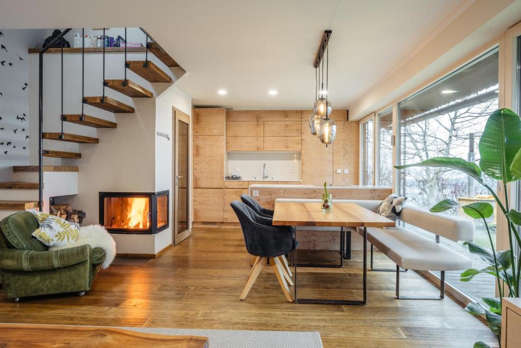 a living room with a table and a fireplace at Boutique Chalet - Herke in Eitweg