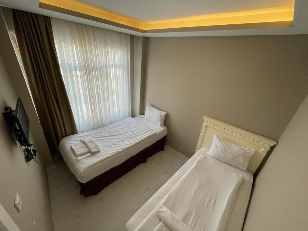 Postel nebo postele na pokoji v ubytování Golden Gate Hotel Topkapı